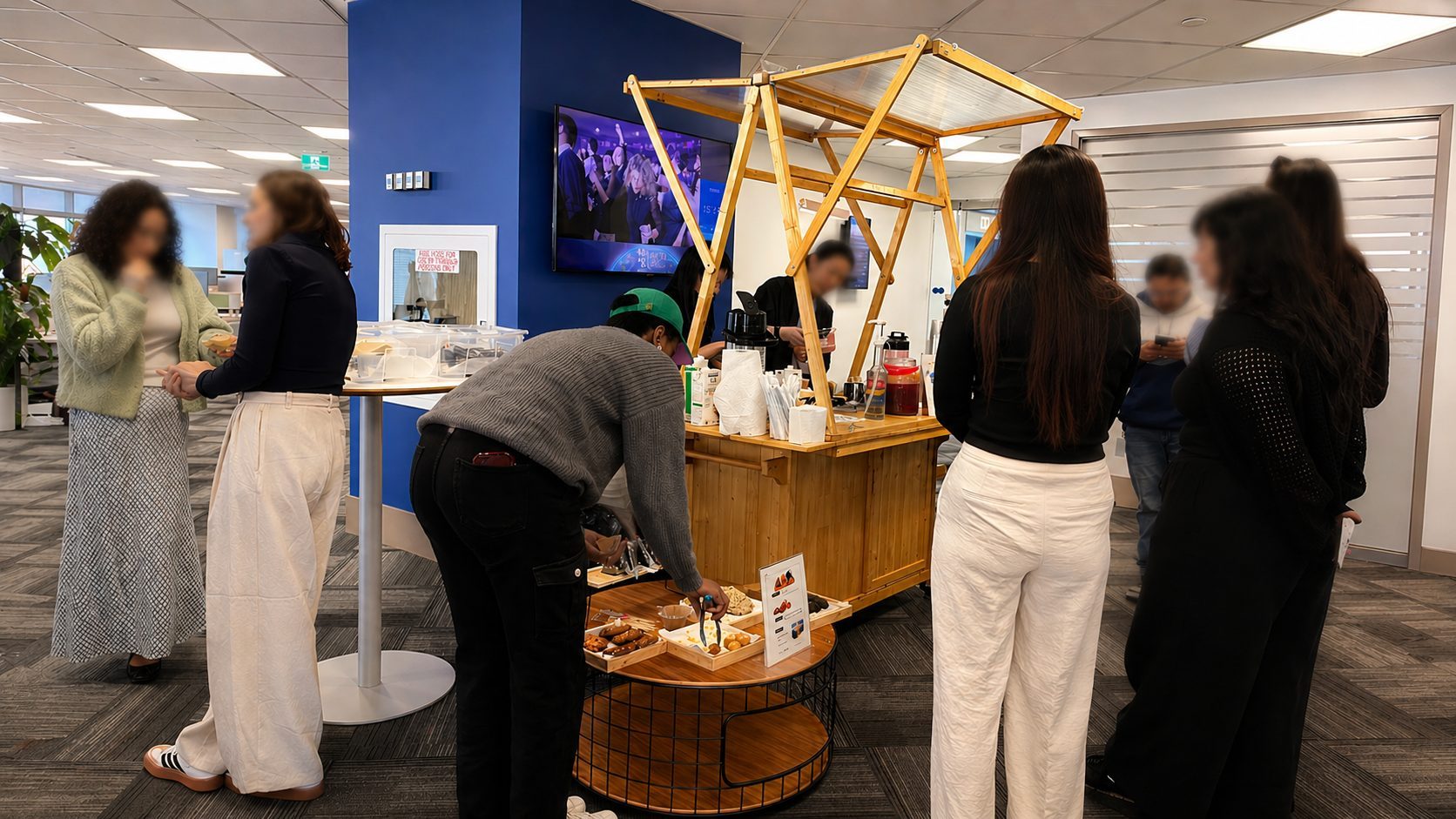 The Gleam & Sip wooden matcha cart set up inside a corporate office in Toronto, with guests gathered for an activation